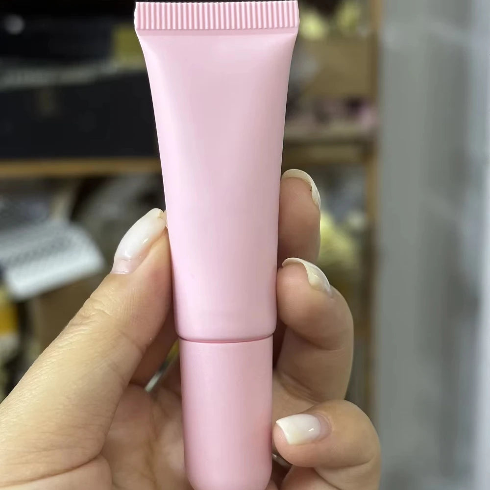 Empty matte plastic squeeze lip balm tubes in white and pink