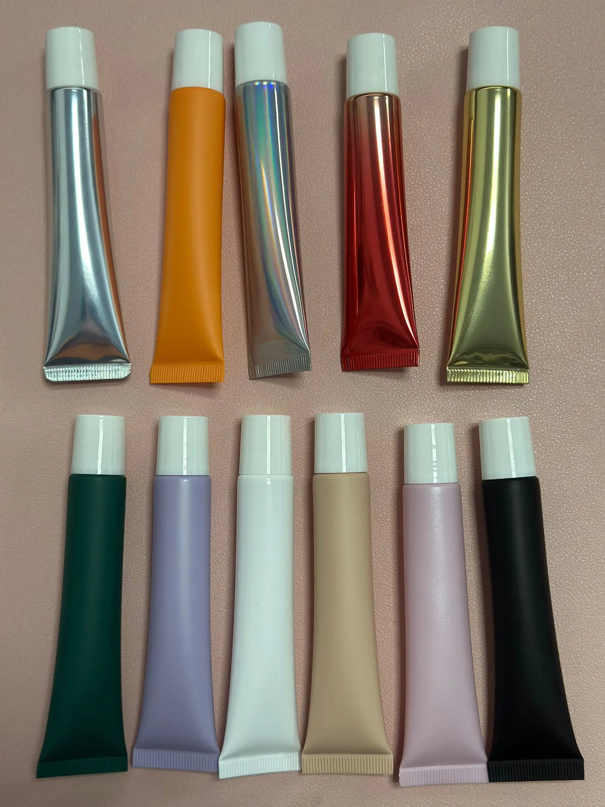 Empty plastic lip gloss squeeze tube with metal applicator