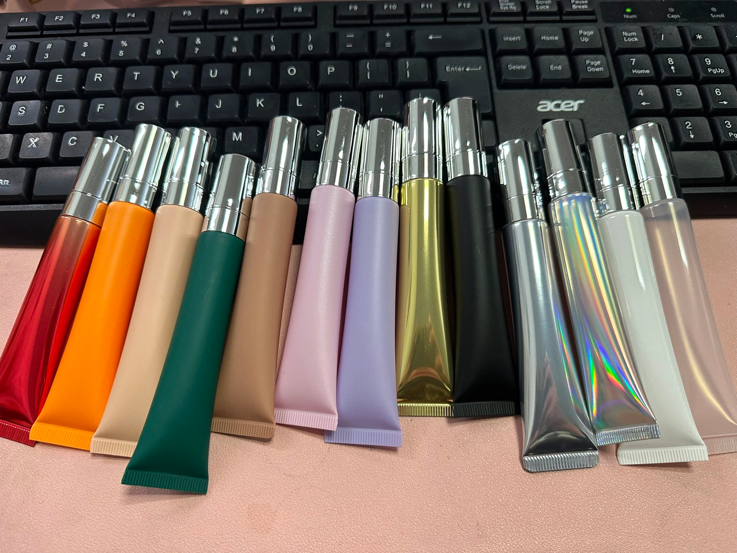 Empty plastic lip gloss squeeze tube with metal applicator