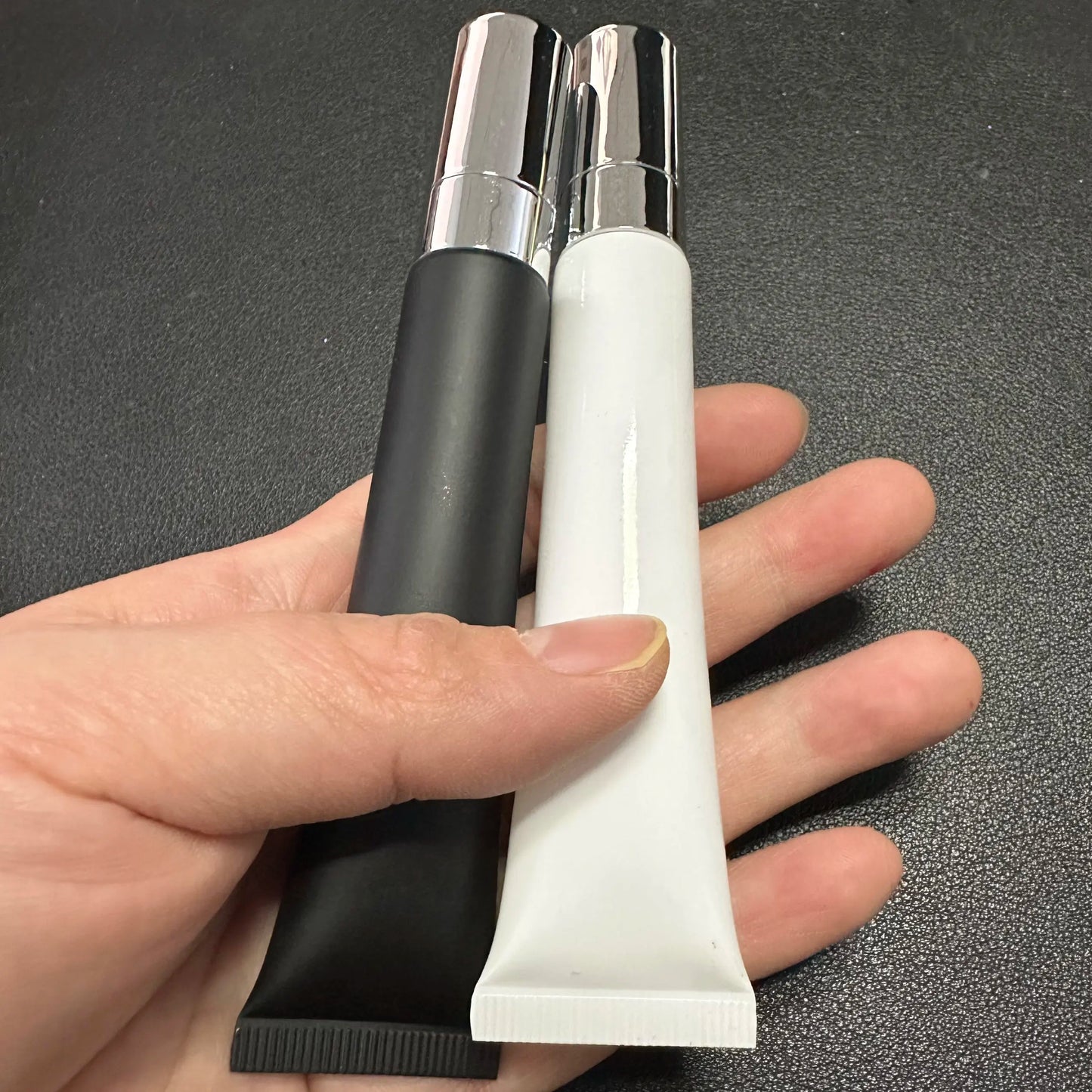 Empty plastic lip gloss squeeze tube with metal applicator