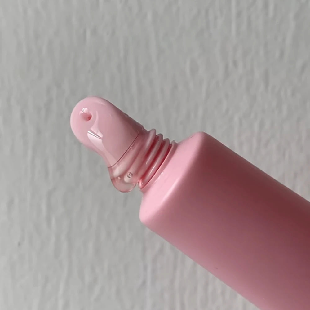 Empty matte plastic squeeze lip balm tubes in white and pink