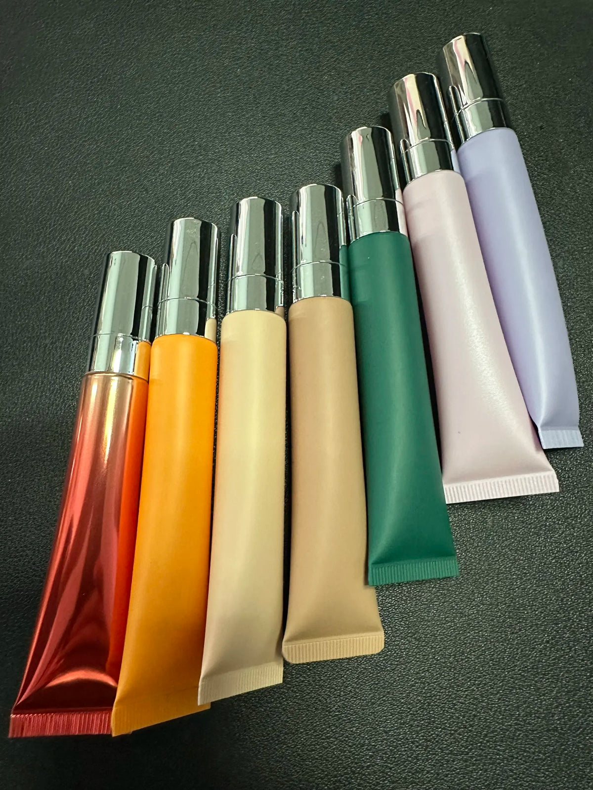 Empty plastic lip gloss squeeze tube with metal applicator