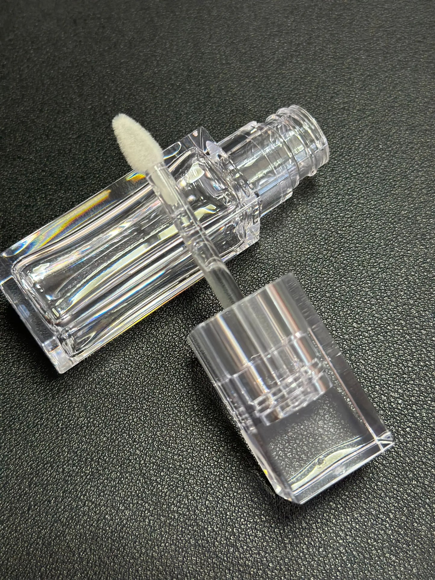Empty clear square lip gloss container with big doe foot applicator