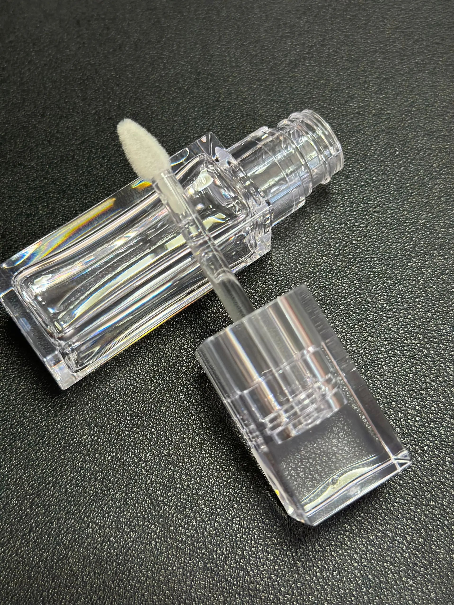 Empty clear square lip gloss container with big doe foot applicator